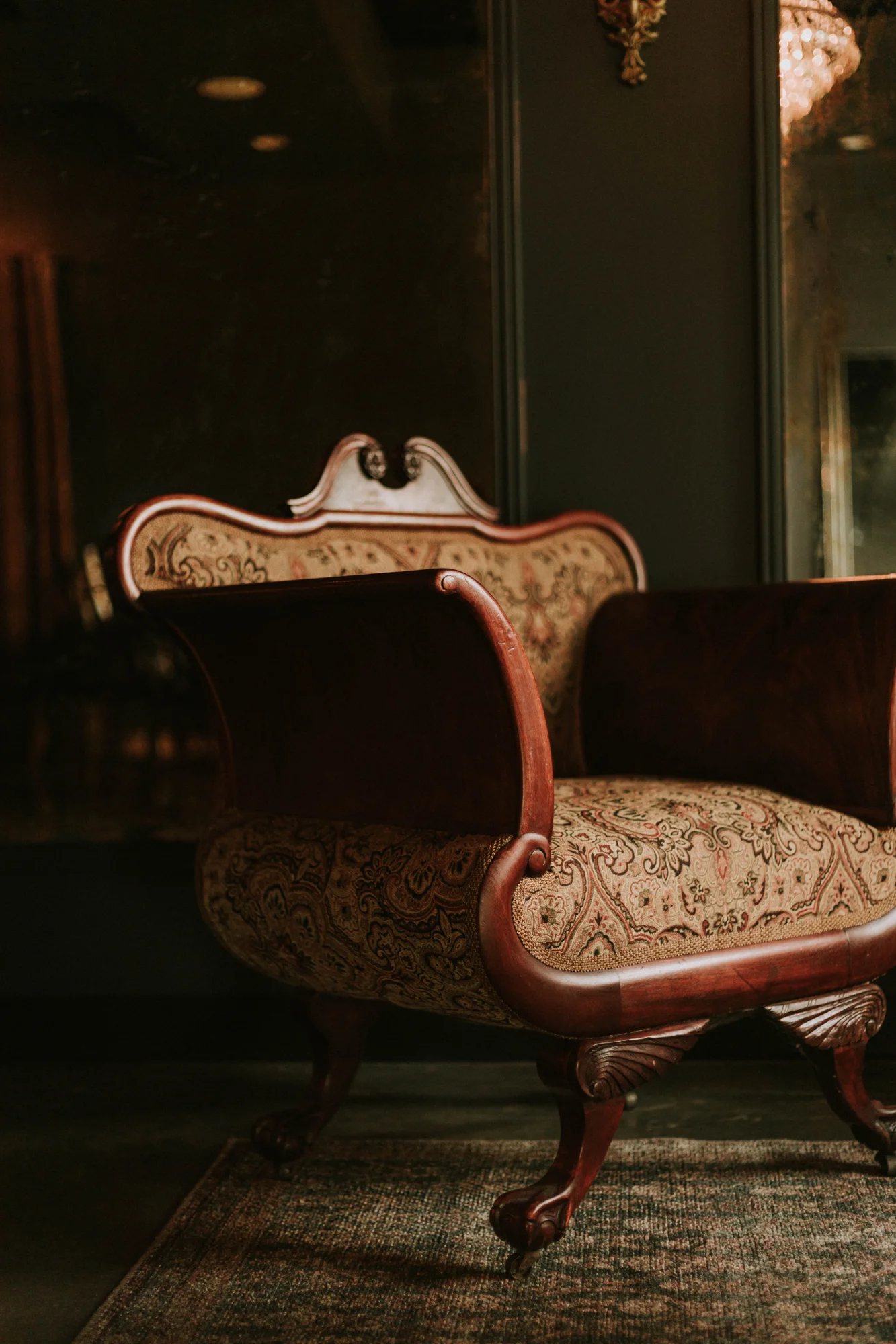 A vintage chair in a richly layered corner of the venue