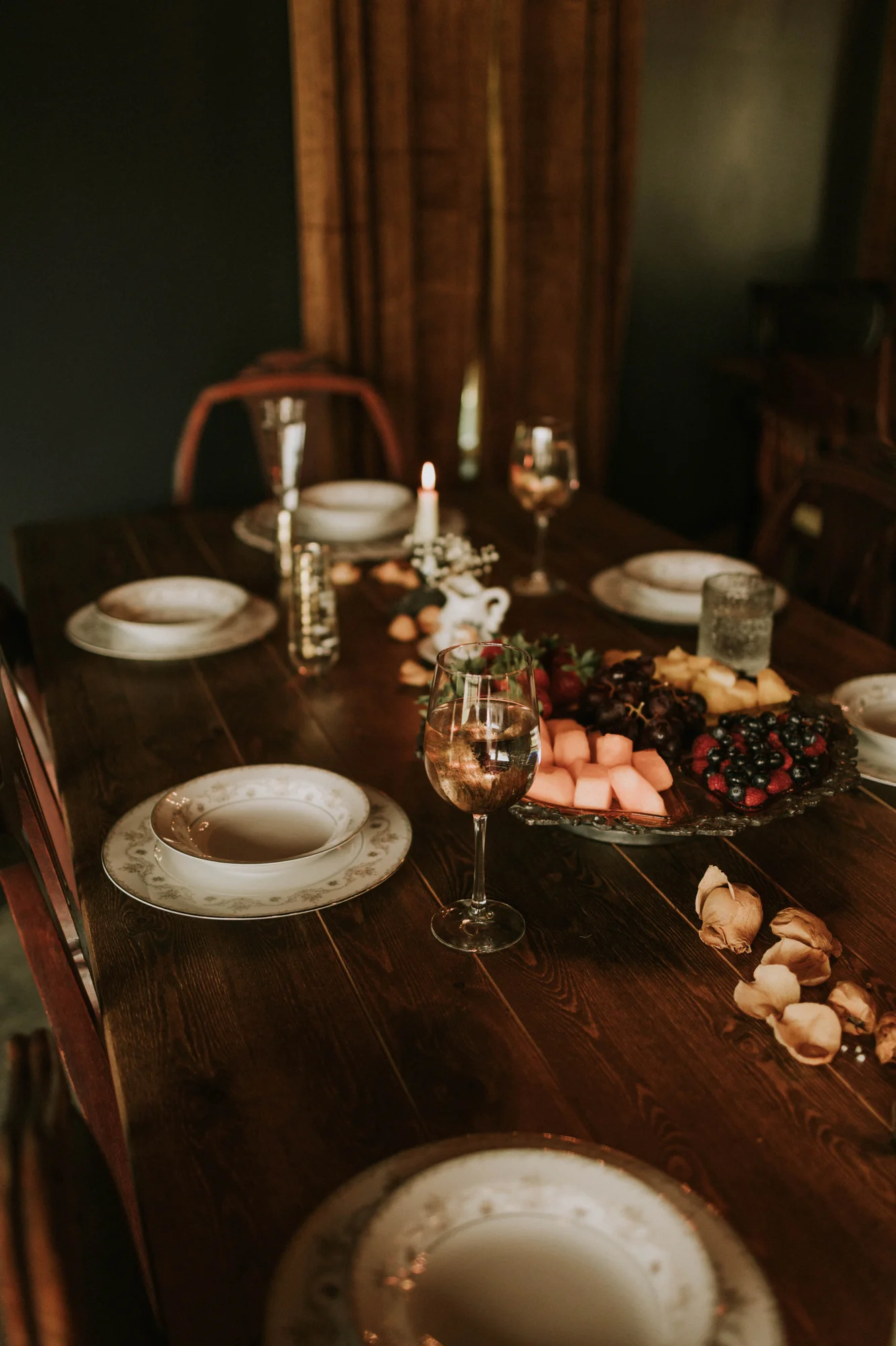 A table arranged with flowers, china, and food