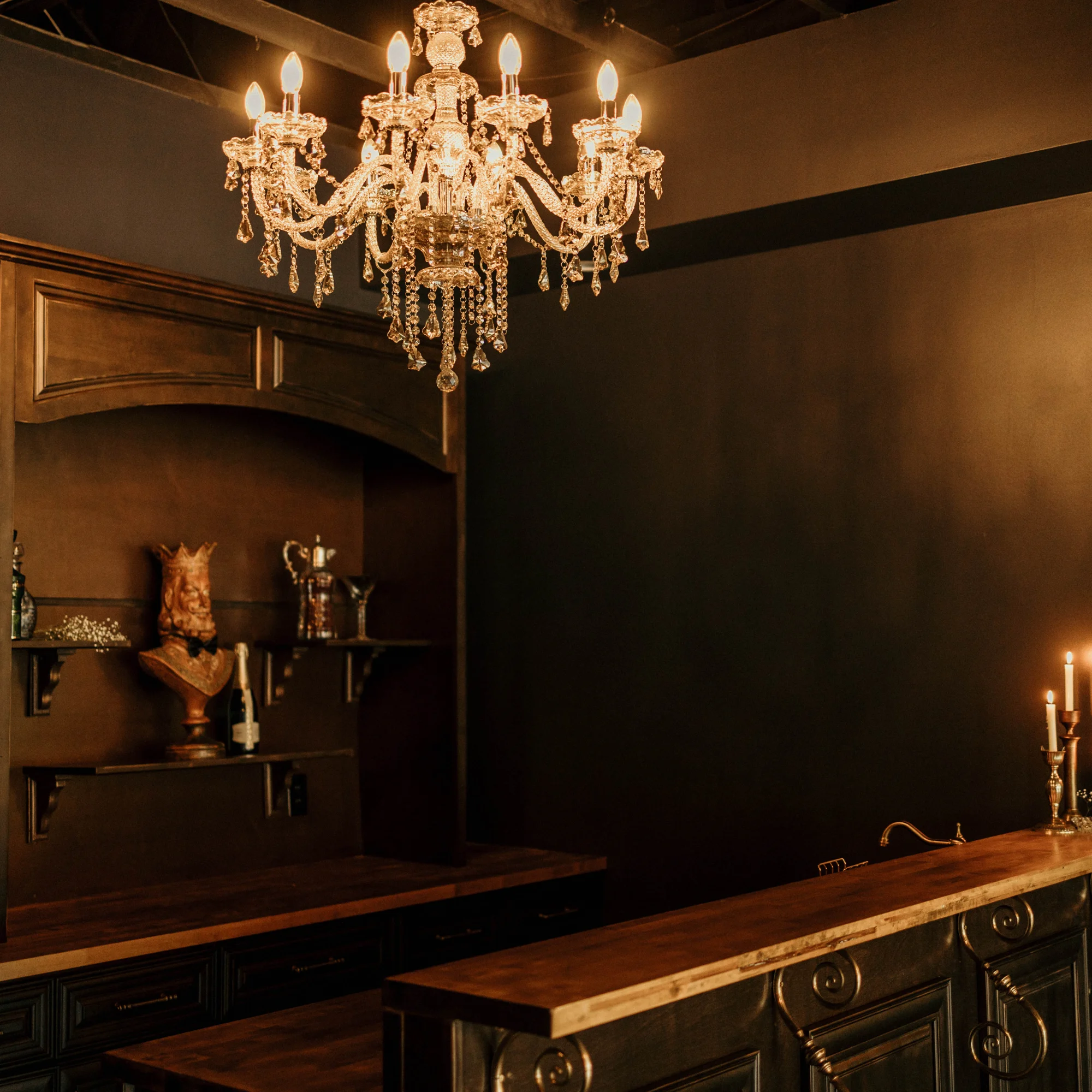 The Parlour’s bar beneath warm chandelier light